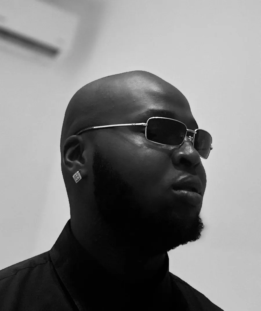 Black and white portrait of CJ Obassey in sunglasses